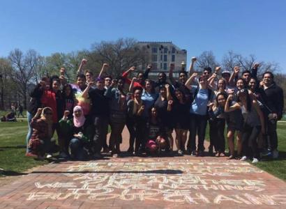Students with fists in air on Oval