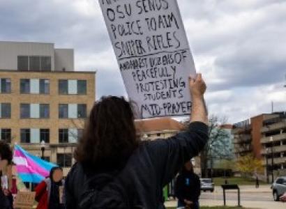 Young woman holding sign