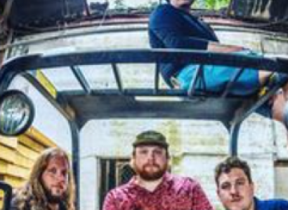 The four men in the band posing 