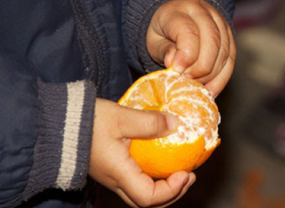 Hands peeling an orange
