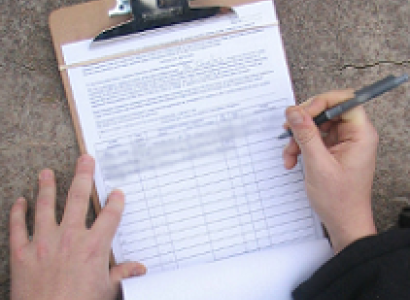 Someone signing a petition