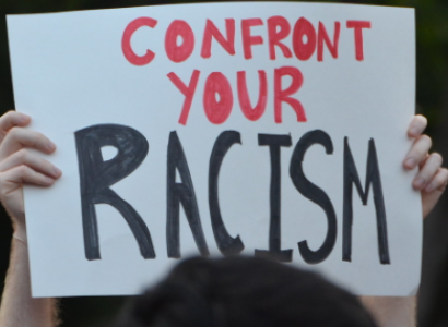 Sign saying confront your racism