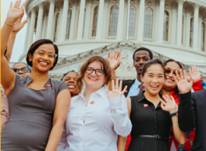 People posing in front of the US Capitol
