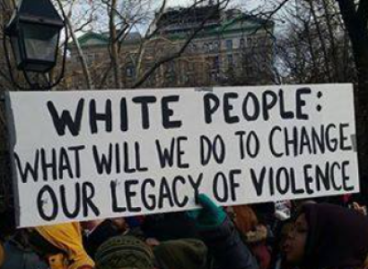 Banner saying White People What will we do to change our legacy of violence