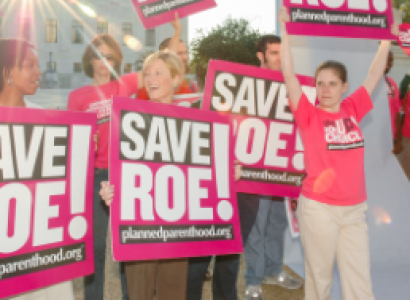 People holding Save Roe signs