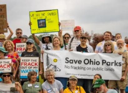 Outdoor protest with signs about Save Ohio Parks