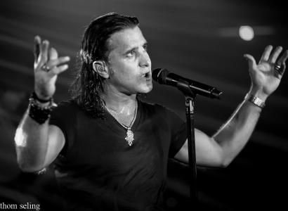 Scott Stapp with arms up singing