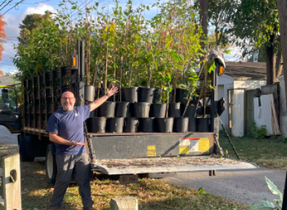 Man posing in front of trees