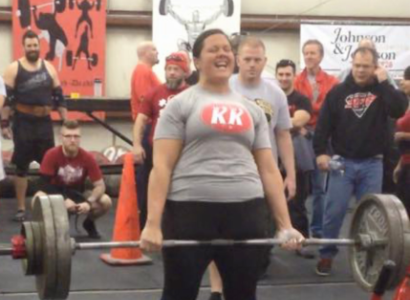 Young woman lifting barbells
