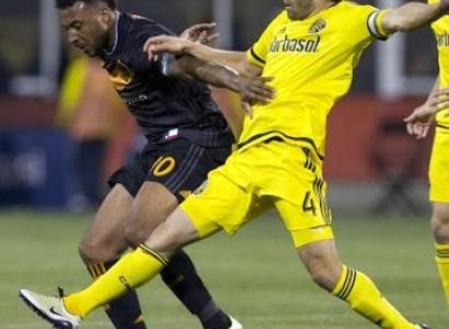 Two soccer players going after the ball