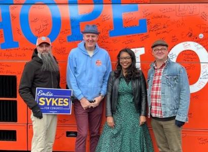 Four people standing and posing