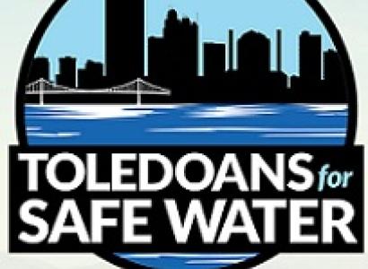 Round logo of a downtown skyline with a bridge and water in front and words Toledians for Safe Water