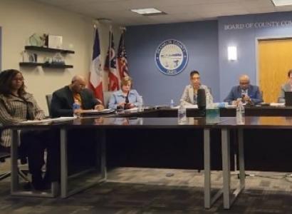 The hearing panel seated at a long table