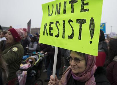 Sign at protest saying Unite Resist