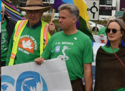 David Swanson marching with World Beyond War banner