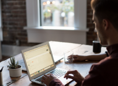Guy working on a laptop at home