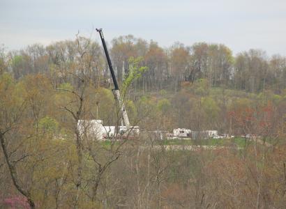 What looks like a crane and extracting equipment within trees in a forest