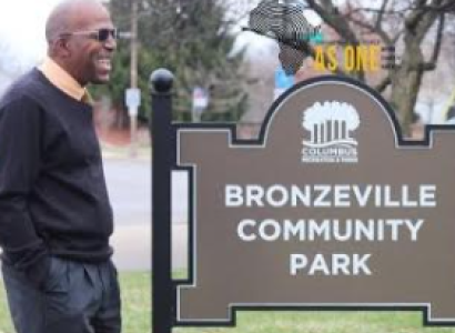 Willis Brown next to Park sign