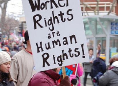People marching and one closeup of a picket sign reading Worker Rights are Human Rights