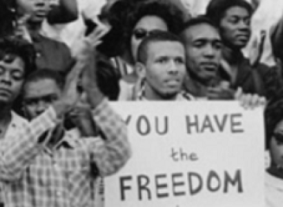 People from 60s with sign saying You Have the Freedom to Vote