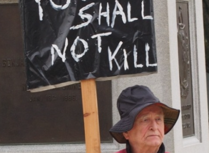 Protester with sign saying You Shall Not Kill