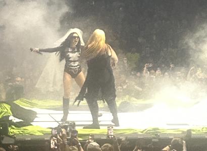 Women on stage at a concert with lots of smoke