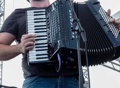 Guy singing with accordion