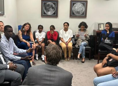 People sitting in a circle at a meeting