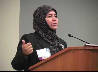 Muslim woman speaking at a mic