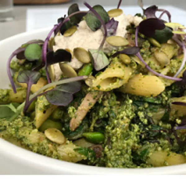 A plate with lots of pasta and green foods on it