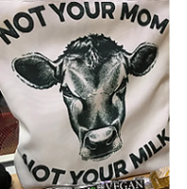 White T-shirt with big cow face in the middle and words Not Your Mom, Not Your Milk