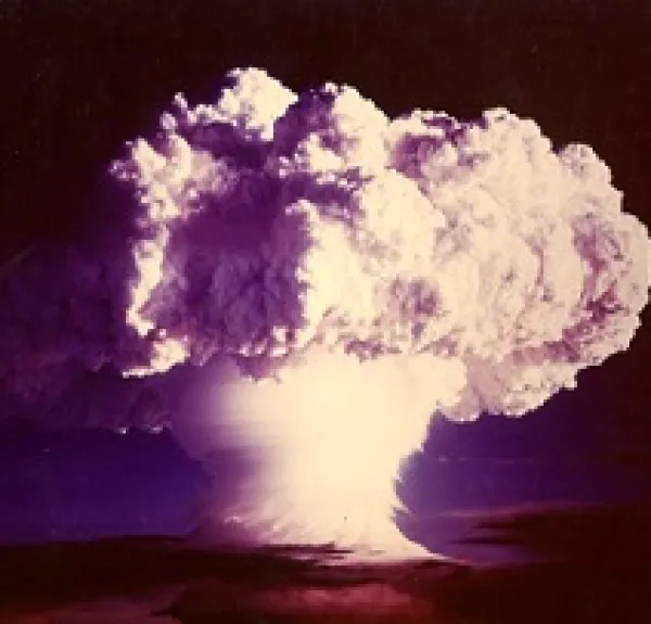 Big burst of a cloud in white all fluffy on top coming off of the ground