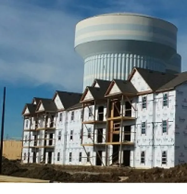 Big halfway built building with a huge water tower in the background