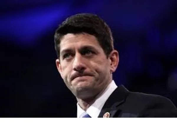 Blue background and head and shoulders of white man with black hair biting him lips as if he's upset