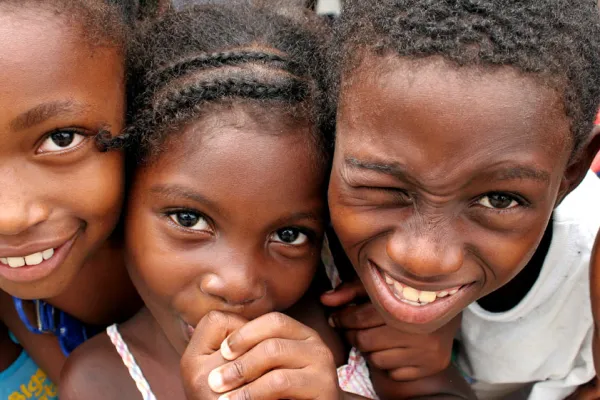Little black girl with braids with two other black kids