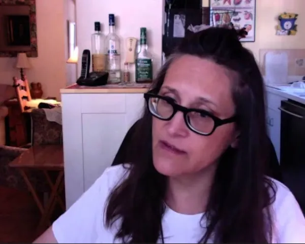 Woman with brown hair and glasses