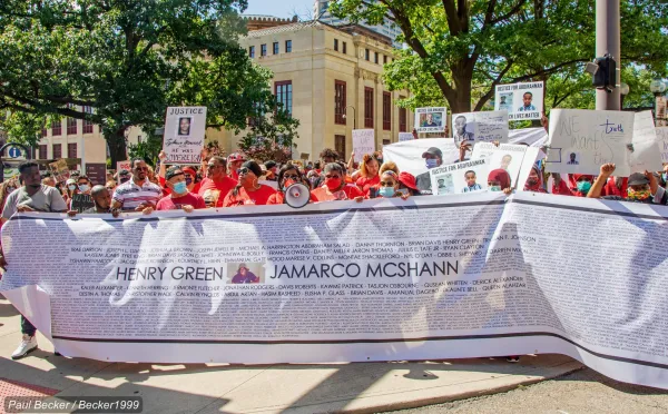 People marching with big banner
