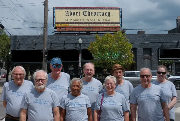 People standing in front of billboard