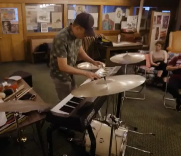 Man playing keyboards and drums