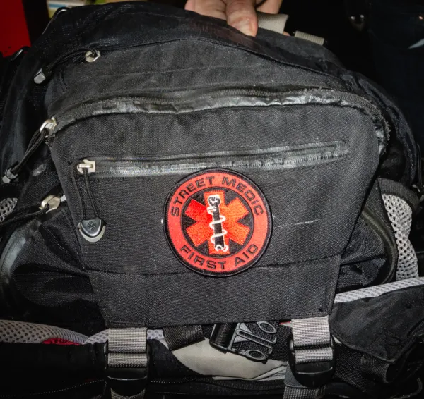 Black medic bag with red First Aid symbol on it
