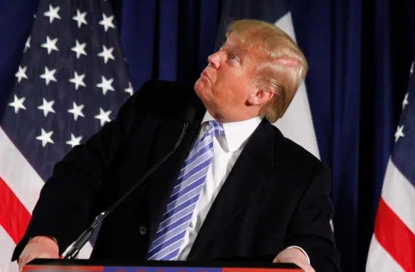 Donald Trump at podium looking sideways and stupid