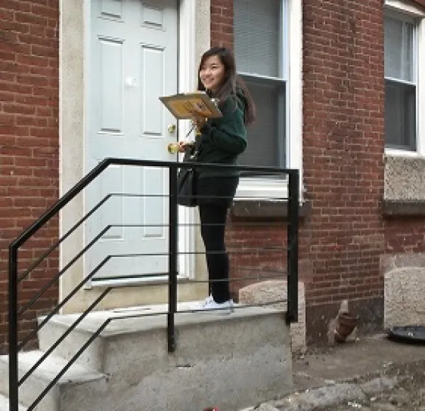 Woman standing outside a door