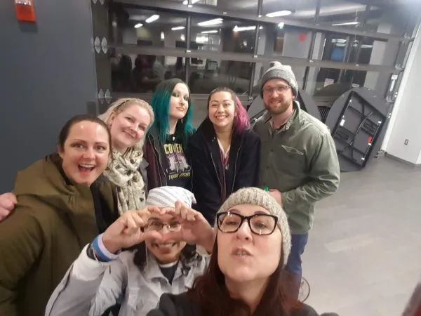 People smiling at camera including Esther Flores