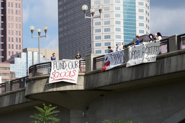 Fund Schools sign hung on overpass