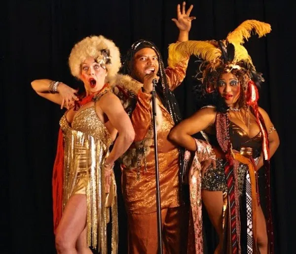 People dressed campy singing and acting