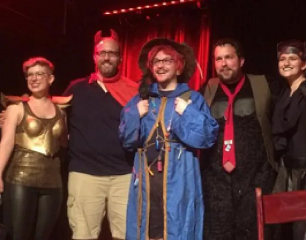 Four people dressed in geeky costumes