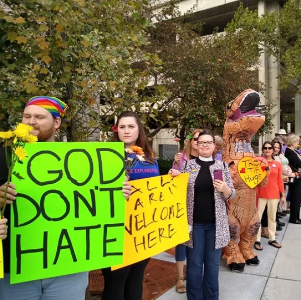 Line of counterprotestors holding signs one saying God Don't Hate
