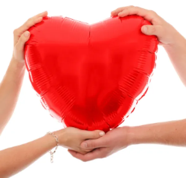 Two hands holding a big red heart