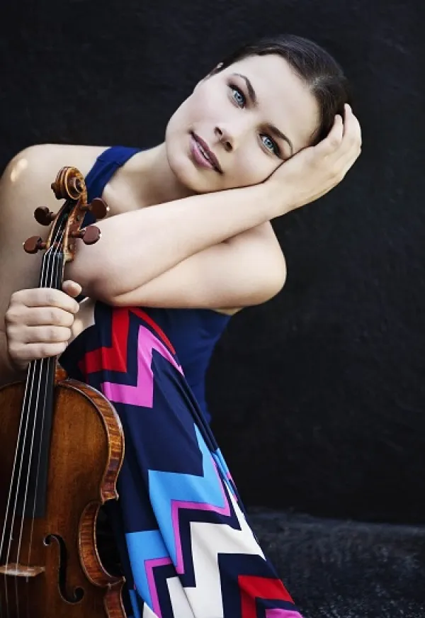 Young woman posing with a violin