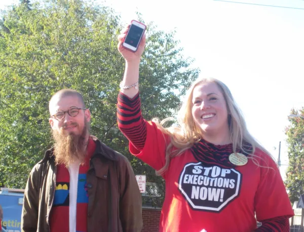 Death row inmate Keith LaMar speaks on the phone to participants in the Walk to Stop Executions as they prepare to walk the last two miles to the Ohio Statehouse on October 10.